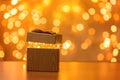 Gift on blurry New Year lights background Royalty Free Stock Photo