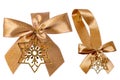 Gift bows. Closeup of a decorative golden ribbon bow made of silk for gift box isolated. Decorations background with star.