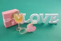 Gift box and alphabet love on green background Royalty Free Stock Photo