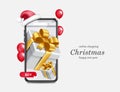 Gift box appears on smartphone screen and has buy icon beneath it for chistmas concept Royalty Free Stock Photo