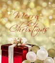 Gift box and baubles with text Merry Christmas Royalty Free Stock Photo