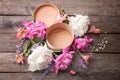 Gift box and beautiful flowers on wooden table Royalty Free Stock Photo