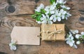 Gift box, blank paper tag and branch plum Royalty Free Stock Photo