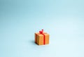 Gift box on blue background. Minimalism. The approach of the New Year holidays or birthday. Sale of gifts, special promotion Royalty Free Stock Photo