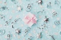 Gift box on blue christmas background decorated confetti and silver stars top view. Flat lay. Royalty Free Stock Photo