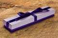 Gift box with blue satin ribbon bow,