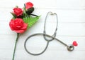 gift box, bouquet of red roses, stethoscope Red hearts, isolate on a wooden table white backdrop, Valentines Day concept. Royalty Free Stock Photo