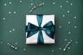 Gift box with bow on green, sea color background with sparkles Royalty Free Stock Photo