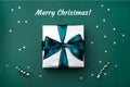 Gift box with bow on green, sea color background with sparkles Royalty Free Stock Photo