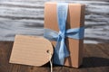 Gift box with bow on wood table front view Royalty Free Stock Photo