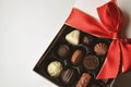 Gift box of chocolates with red ribbon