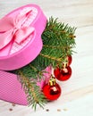 Gift box with christmas baubles and pinetree