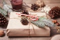 Gift box and Christmas decor on the wooden table. Christmas present decoration. Handmade decor concept