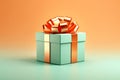 Gift box. Christmas present. Green gift box with orange bow on abstract light festive orange and turquoise background Royalty Free Stock Photo