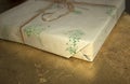 Gift box in craft paper lying on a table Royalty Free Stock Photo