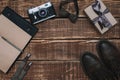 Gift box for father`s day with men`s accessories bow tie, wallet, retro camera, suspenders and notepad and leather shoes on a