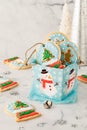 A gift box filled with snow globe cookies with twine ties for hanging on a tree. Royalty Free Stock Photo