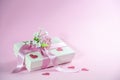 Gift box with flower bouquet, ribbon and paper heart shapes on a light pink background, love greeting card for Valentines day, Royalty Free Stock Photo