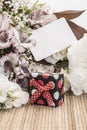 Gift box and flowers with an empty tag Royalty Free Stock Photo