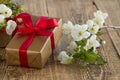 Gift box with flowers on the wooden background Royalty Free Stock Photo