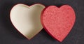 Gift box in the form of a red heart on a satin beige fabric. Royalty Free Stock Photo