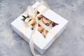 Gift box with fruit cupcakes. Holiday cupcakes with strawberry and blueberry. Cupcakes packaging, delivery box on grey background