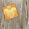 Gift box with gold ribbon with bow on Vintage wooden background Royalty Free Stock Photo