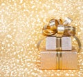 Gift box in gold wrapping paper Royalty Free Stock Photo