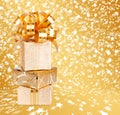 Gift box in gold wrapping paper on a beautiful background Royalty Free Stock Photo