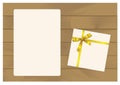 Gift Box with Golden Bow and Sheet of paper Isolated on Wooden Plank Background.