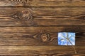 Gift box with golden bow on wooden table