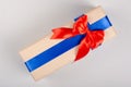 Gift box on gray background composition, present with ribbon and bow Royalty Free Stock Photo