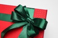 Gift box with green bow on light grey background, closeup Royalty Free Stock Photo