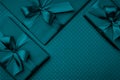 Gift box with green ribbon bow dark turquoise background top view. Holiday concept, birthday gift, New year or Christmas Royalty Free Stock Photo