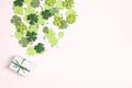 Gift box with green ribbon and clover leaves on white background. Lucky shamrock, St.Patrick`s day background Royalty Free Stock Photo