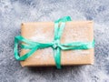 Gift box with green ribbon and snow