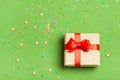 A gift in a box on a greenery background