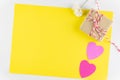 Gift box and Hand-made pink love hearts isolated on yellow texture background, Happy valentine`s day.