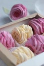 Gift box of handmade black currant and banana marshmallow (zephyr). Close up view of creamy pale yellow and