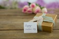 Gift box with happy mother day card on wooden surface Royalty Free Stock Photo
