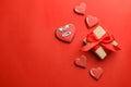 Gift box and heart shaped cookies on red background Royalty Free Stock Photo