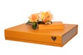 Gift box isolated. Close-up of a big and a small golden gift box with a bouquet of beautiful orange roses on it isolated on a Royalty Free Stock Photo