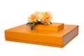 Gift box isolated. Close-up of a big and a small golden gift box with a bouquet of beautiful orange roses on it isolated on a Royalty Free Stock Photo