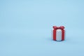 Gift box isolated on sky blue background. 3d white gift box with red ribbon and bow. holiday surprise box. birthday celebration Royalty Free Stock Photo