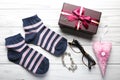 Gift box, jewelry accessories, socks and other on wooden background