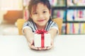 Gift box for kids girl. White box with red bow in the girl hands for give a gift Royalty Free Stock Photo