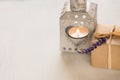 Gift box with a lavender twig, heart shaped candle holder with burning tea light on white background Valentine`s day Royalty Free Stock Photo