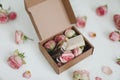 Gift box with natural homemade soap bars and rose flowers on white background. Holiday gift, opening present, top view. Royalty Free Stock Photo