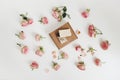 Gift box with natural homemade soap bars and rose flowers on white background. Holiday gift, opening present, top view. Royalty Free Stock Photo