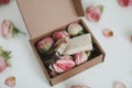 Gift box with natural homemade soap bars and rose flowers on white background. Holiday gift, opening present, top view. Royalty Free Stock Photo